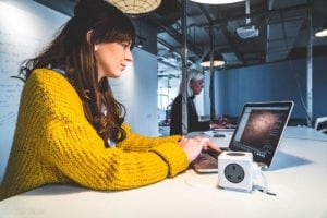 Photo of young woman at CodeClanworking on a Mac