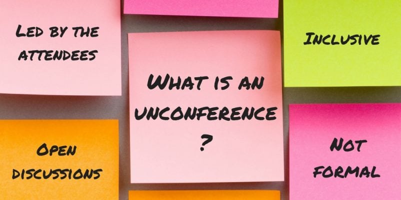 A pink post-it note with 'what is an unconference?' written on it in black text