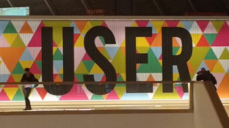 The word user spelled out in black capital letters on a multicoloured background.