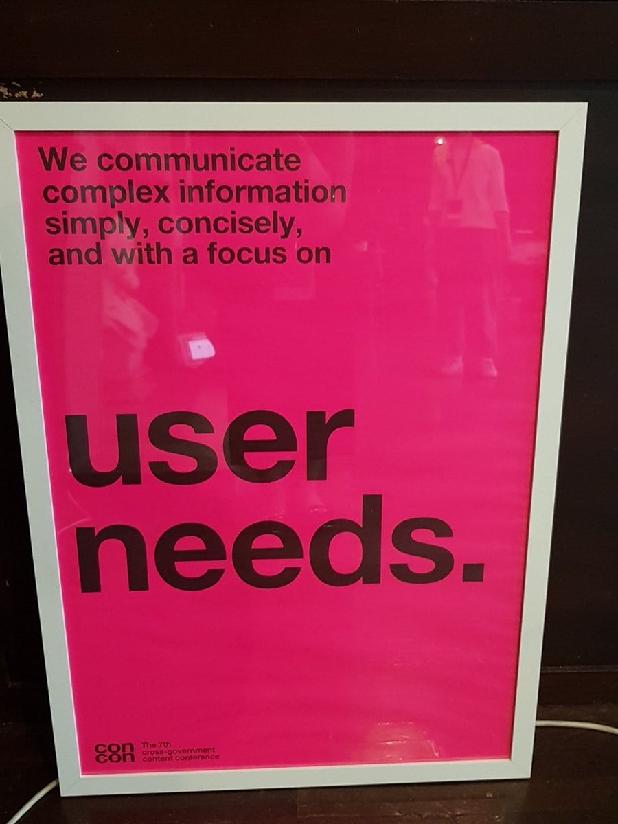 Poster from 2018 cross government content design conference that says "we communicate complex information simply, concisely and with a focus on user needs.