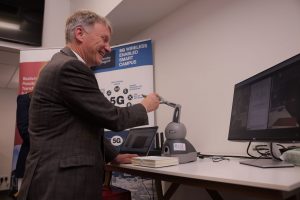 Minister for Business, Trade, Tourism and Enterprise, Ivan McKee, interacting with robotic arm.