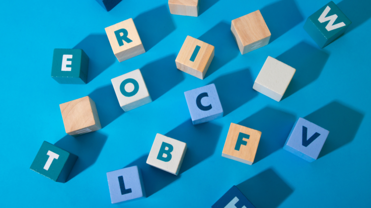 Letter blocks scattered on a blue background